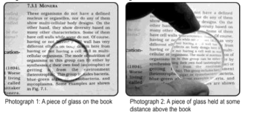 Rajan takes the following two photographs of the text in a book, first while keeping a circular piece of glass on the book, and then while holding it at some distance above the book.      Which of the following statements is true about the piece of glass?