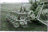 Before sowing the crop seeds, the soil of fields is loosened and overturned. This process is called ploughing or tilling. For sowing, farmers obtain certified seeds from State Agriculture Department and Seed Corporation. Sometimes, farmers also select seeds from their own crop. Nowadays ploughing is done by a tractor driven cultivator as shown in the figure below. The use of cultivator saves labour and time. A farmer does ploughing and simultaneously releases seeds from the funnel. Seeds thus released pass through iron pipe to the soil furrows which are formed by the plough. Read the passage and try to answer the below questions:      (a) Name the process shown in the figure.   (b) Explain the process shown in the given figure.   (c ) How does ploughing affect soil fertility?   (d) Why turning and loosening is very important for cultivation of crops?